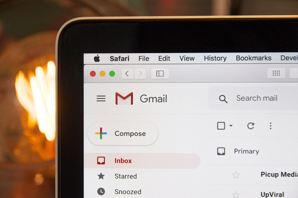 A laptop screen displaying the Gmail inbox interface in the Safari browser, highlighting Gmail’s organized layout and intuitive features.